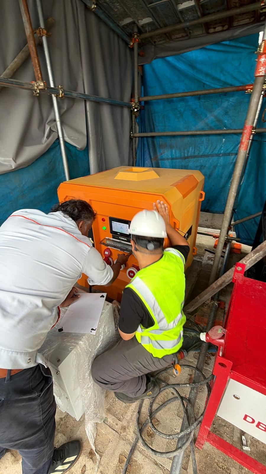 Engineers commissioning an EH-Series battery energy storage system on a Singapore worksite