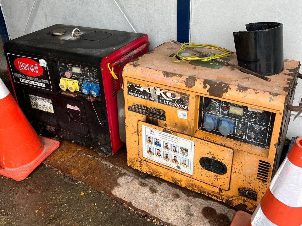 Two ageing diesel generator sets parked beside a Singapore worksite, the equipment the EH-Series was built to replace